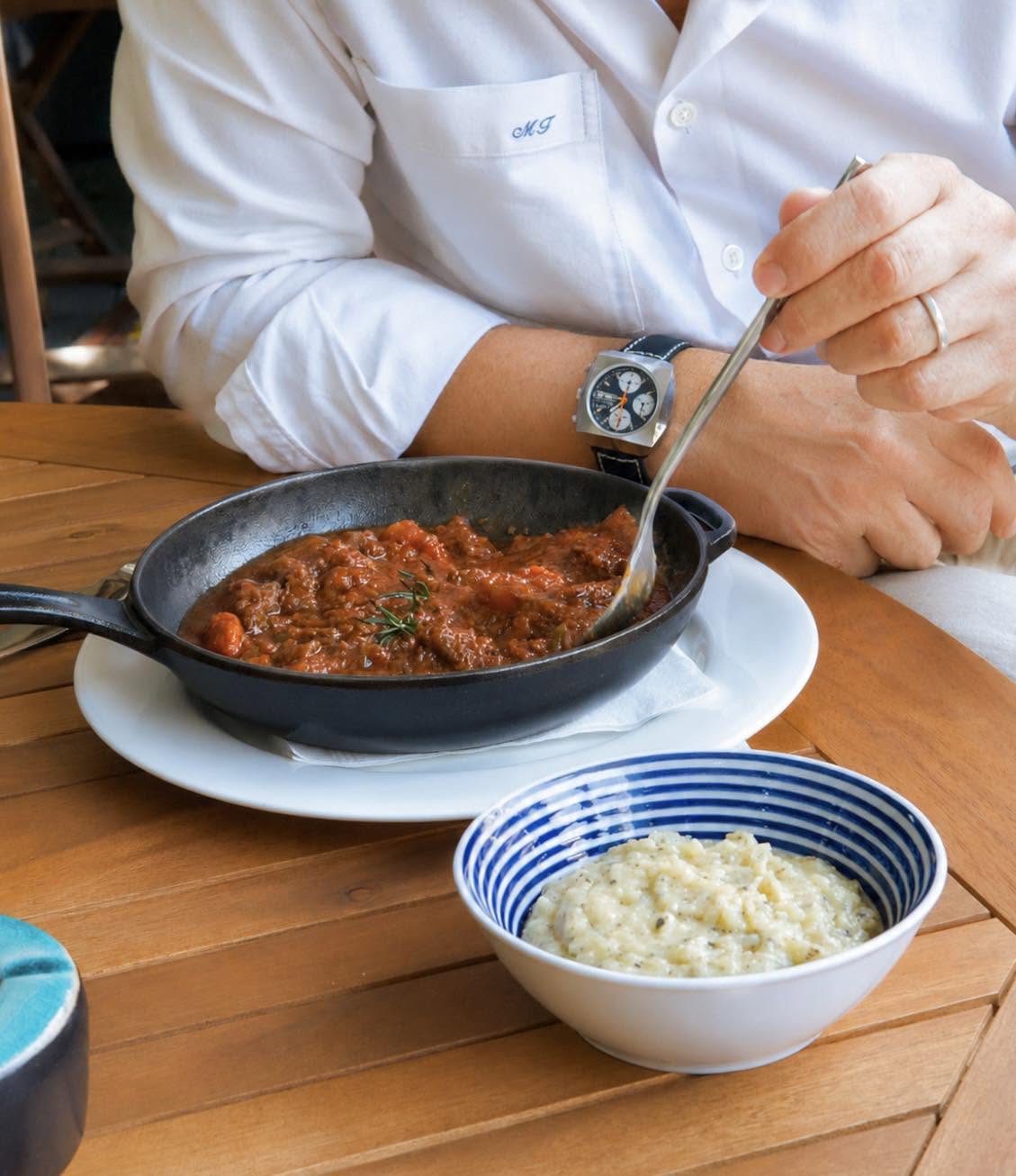 Guest enjoying braised beef and risotto at Bellini