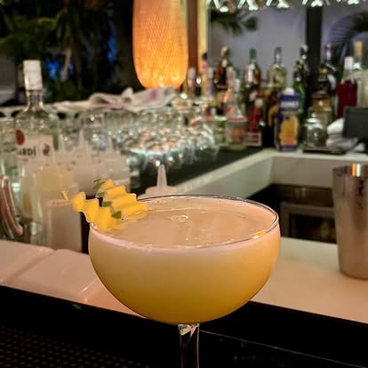 Craft cocktail at Bellini bar — yellow with pineapple garnish
