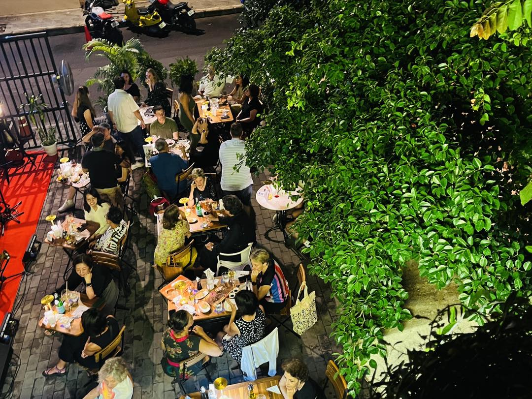 Aerial view of packed Bellini garden at night