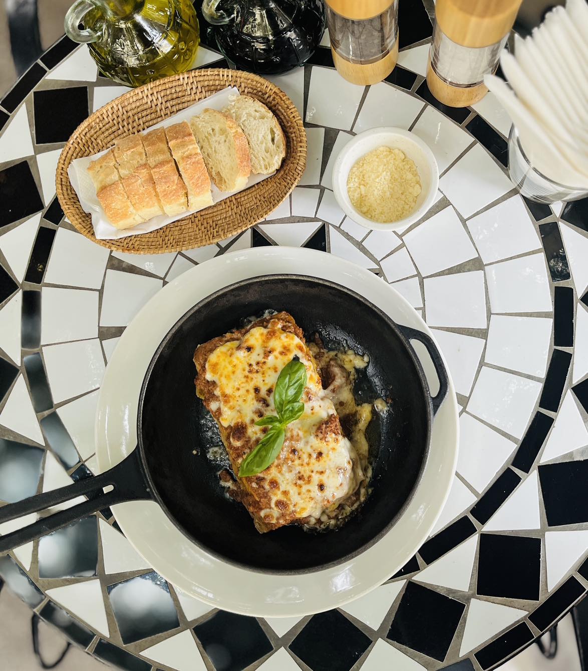 Lasagne in cast iron skillet at Bellini, overhead view